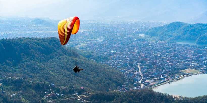 Pokhara Paragliding - Gliding above Pokhara: Phewa Lake, forests, villages, and mountain hints